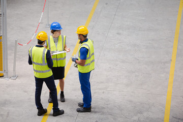 Supervisor and workers talking in factory