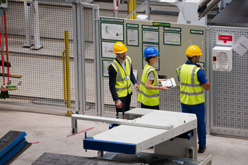 Supervisor and workers talking in factory