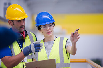 Supervisor and worker talking in factory