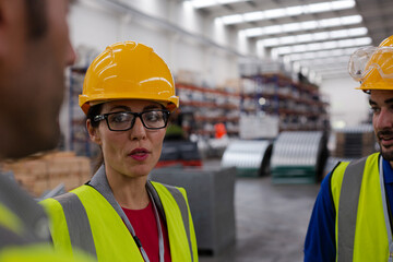 Workers talking in steel factory