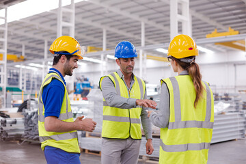 Supervisor and workers talking in steel factory