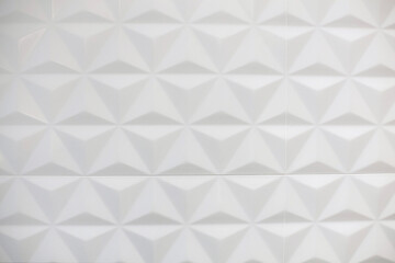 White wall with geometric pattern in triangular shape.