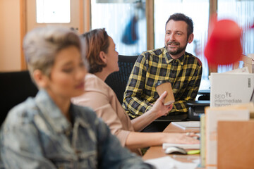 Colleagues working in open plan office