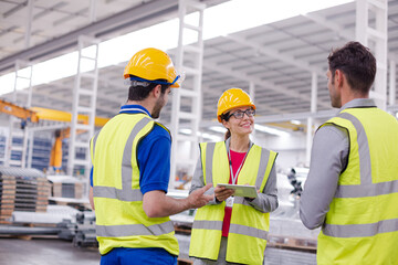 Supervisor and workers talking in steel factory