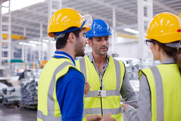 Supervisor and workers talking in steel factory