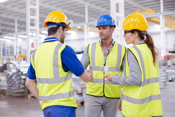 Supervisor and workers talking in steel factory