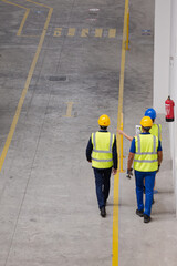 Supervisor and workers talking in factory