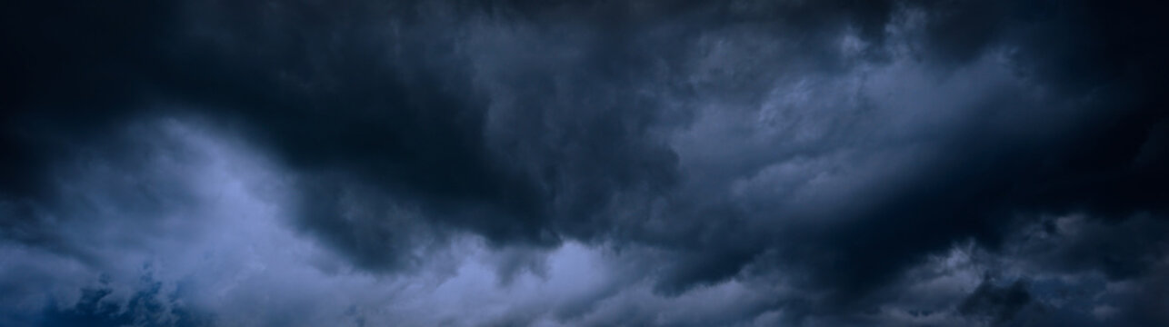 Heavy gray storm clouds. Gloomy sky background for design. Web banner. Website header.