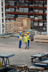 Workers and supervisor talking in factory