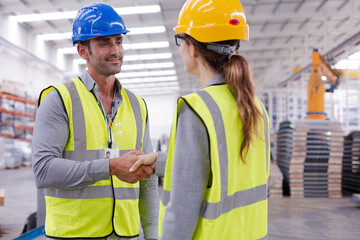 Supervisors handshaking in warehouse