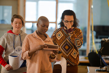 Colleagues talking in office smiling