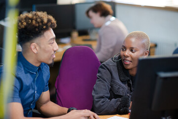 Two colleagues working together at computer
