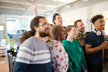 Team taking group selfie in office