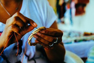 Midsection of female artisan preparing handmade decoration in retail shop