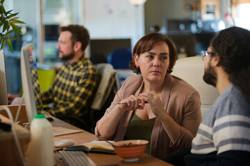 People working at desk, talking