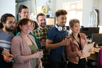 Team taking group selfie in office