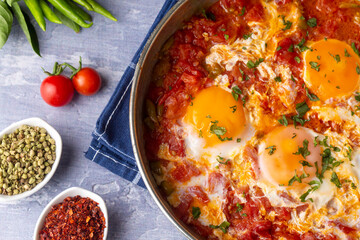 Famous Turkish menemen dinner on table, made by eggs, pepper and tomatoes.