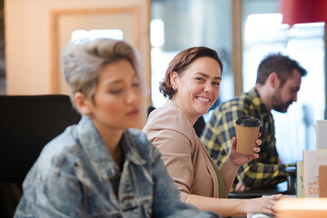 Fototapeta premium Colleagues working in open plan office