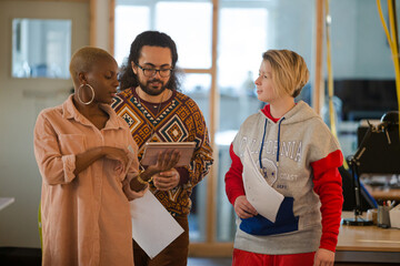 Colleagues talking in office smiling