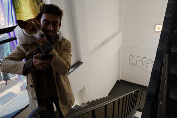 Portrait of smiling young man holding dog