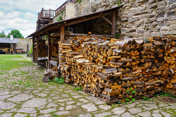Firewood cut and stacked on the street in a medieval looking street. Estonia.
