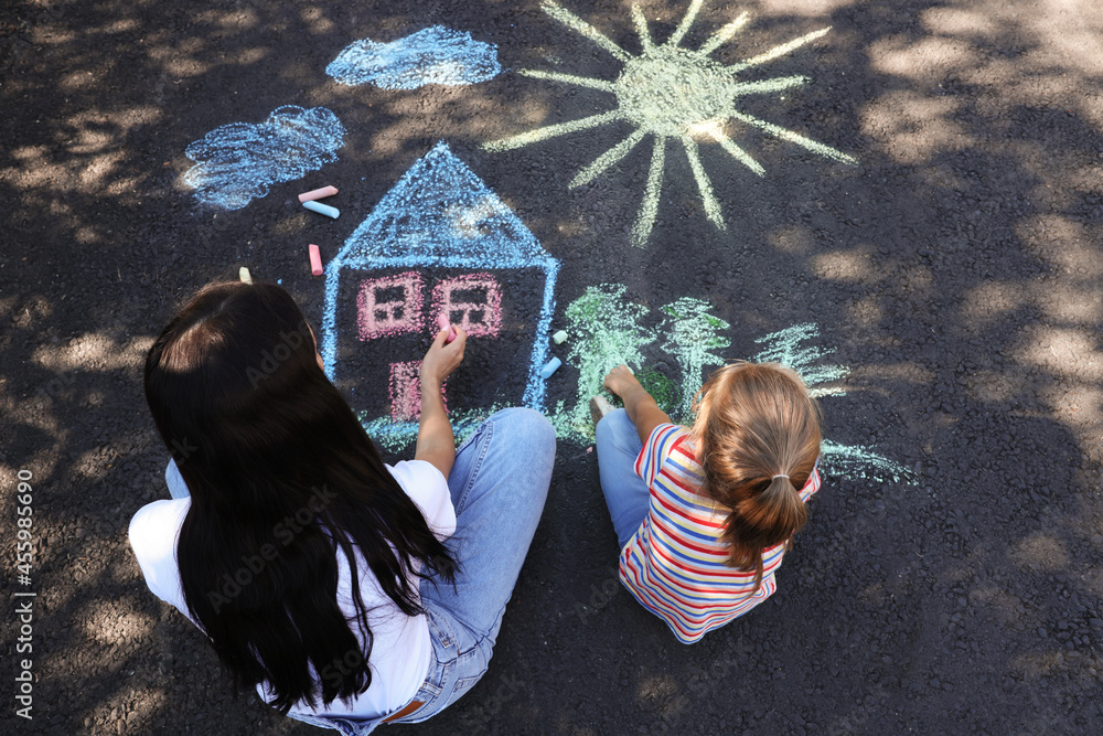 Canvas Prints Little child and her mother drawing with colorful chalks on asphalt, above view