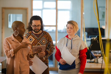 Colleagues talking in office smiling