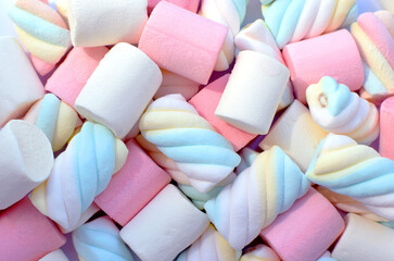 Multi-colored marshmallows. Top view. Background or texture of colorful blue and pink marshmallows.