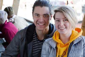 Portrait of smiling couple dining with friends at restaurant outdoor patio