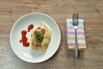 lasagna stuffed pasta topping grilled pork bacon dressing ketchup on plate