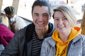 Portrait of smiling couple dining with friends at restaurant outdoor patio