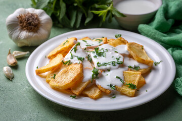 Traditional delicious Turkish foods, fried potatoes with yoghurt (Turkish name; Yogurt soslu patates kizartmasi)