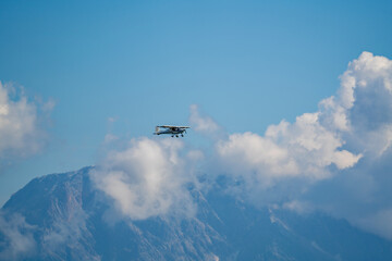 Fototapeta na wymiar a piper in the air over the cloudy alps in austria