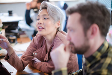 Colleagues working together at laptop