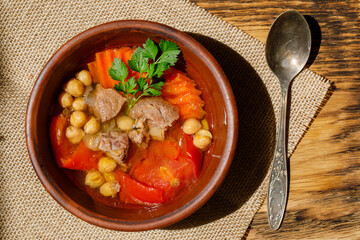 Uzbek nahot shurpa , soup with vegetables and chickpeas, Top view. Central Asian cuisine
