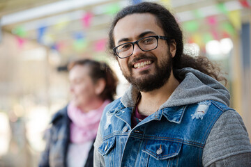 Portrait of smiling young man with beard and long hair