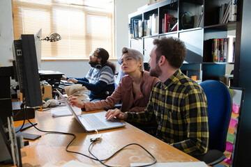 Colleagues working at computer in office