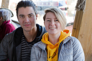 Portrait of smiling couple dining with friends at restaurant outdoor patio