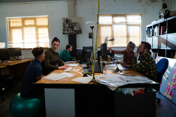 Colleagues working in open plan office