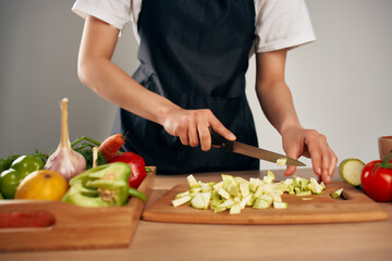 slicing fresh vegetables ingredients for salad healthy food in the kitchen