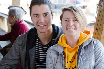 Portrait of smiling couple dining with friends at restaurant outdoor patio