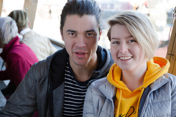 Portrait of smiling couple dining with friends at restaurant outdoor patio