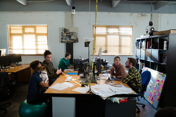 Colleagues working at computer in office