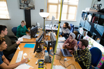 Colleagues working at computer in office