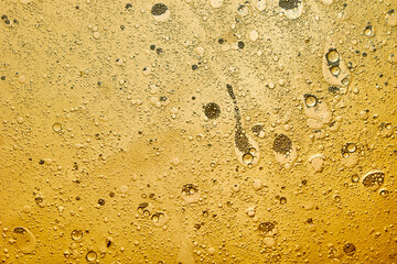 abstract background of yellow bubbles generated in water and oil