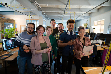 Team posing in office, smiling