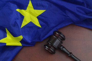 Judge gavel with European Union flag on wooden table. Justice and laws in EU concept.	