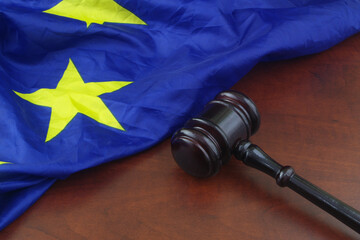 Wooden gavel with European Union flag on wooden background Court and laws in EU concept.	