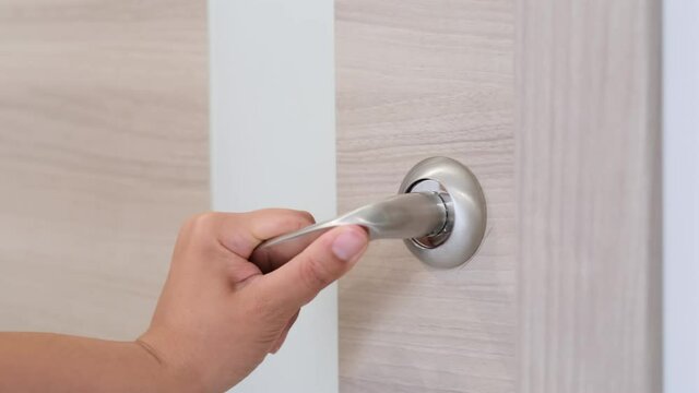 close up woman hand opening door in bedroom