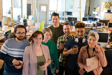 Team posing in office, smiling